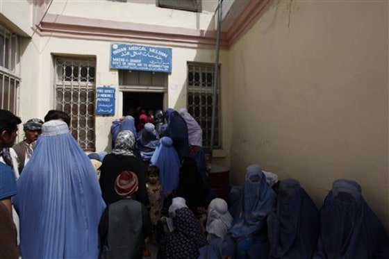Afghan women and children wait to be treated at a hospital supported by India in Mazar-i-Sharif on April 14. India's assistance is just one part of a drive for influence over Afghanistan that has angered Pakistan.